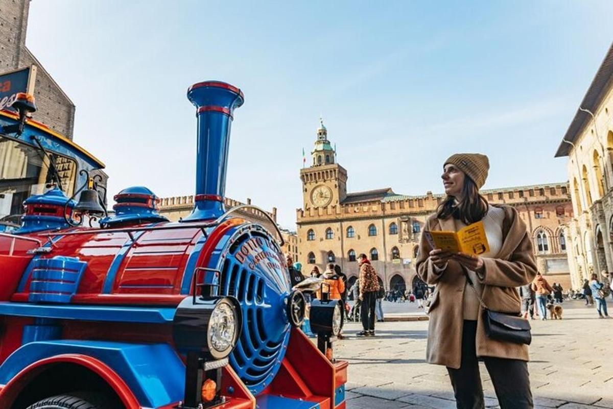 a woman standing next to a red and blue train