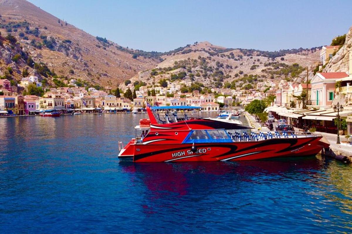 a red boat is docked in a body of water