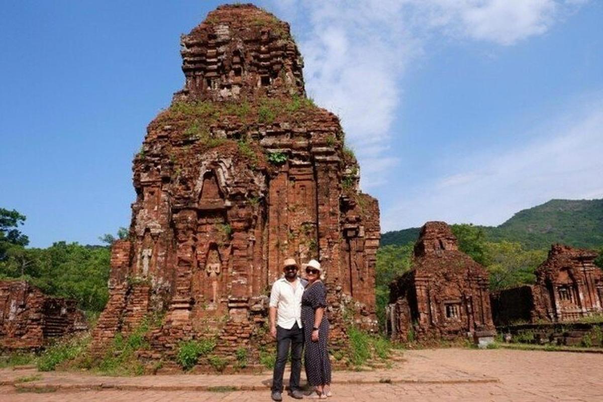 two men standing in front of a stone structure