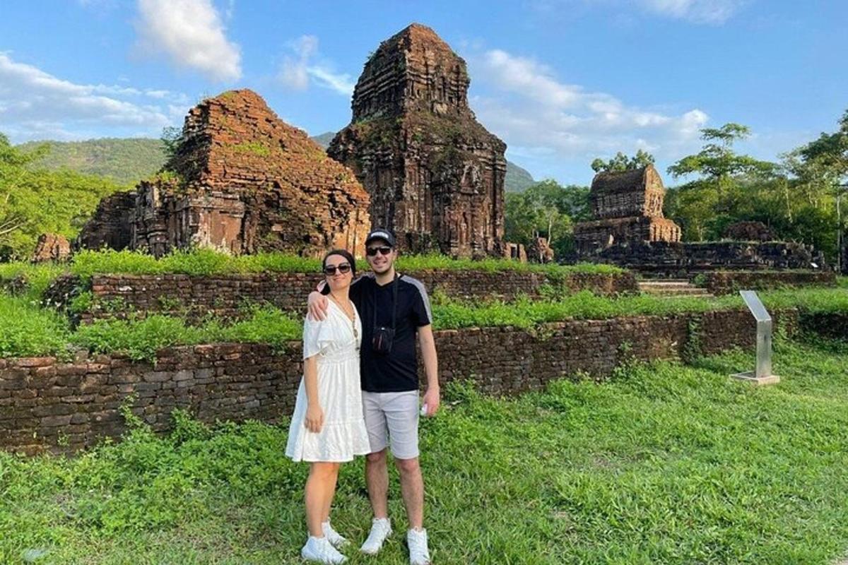 a man and a woman standing in front of a temple