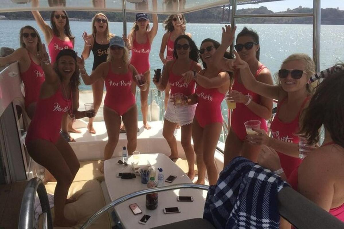 a group of women in pink bathing suits on a boat
