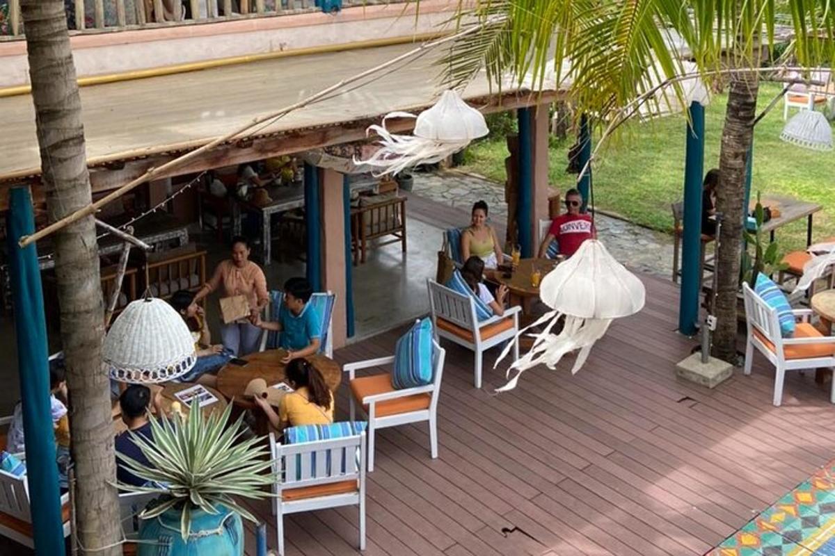 a group of people sitting at a table on a deck
