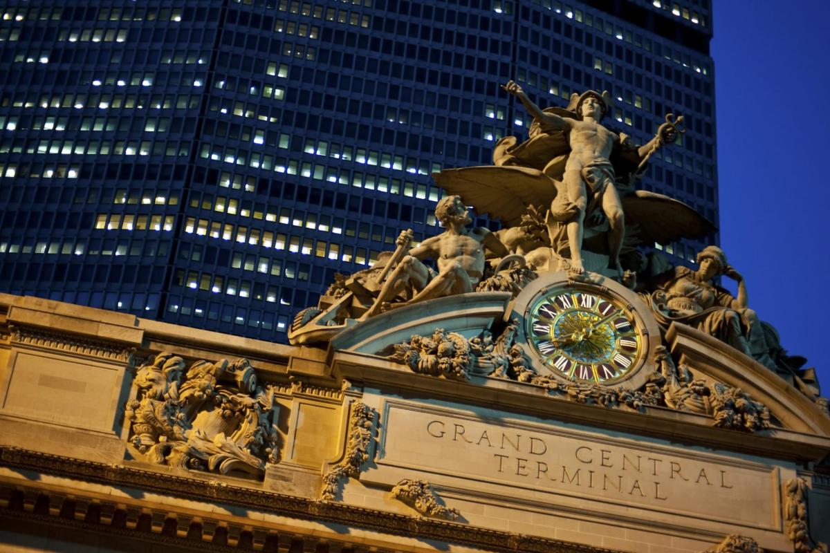 a statue on the top of the grand central terminal