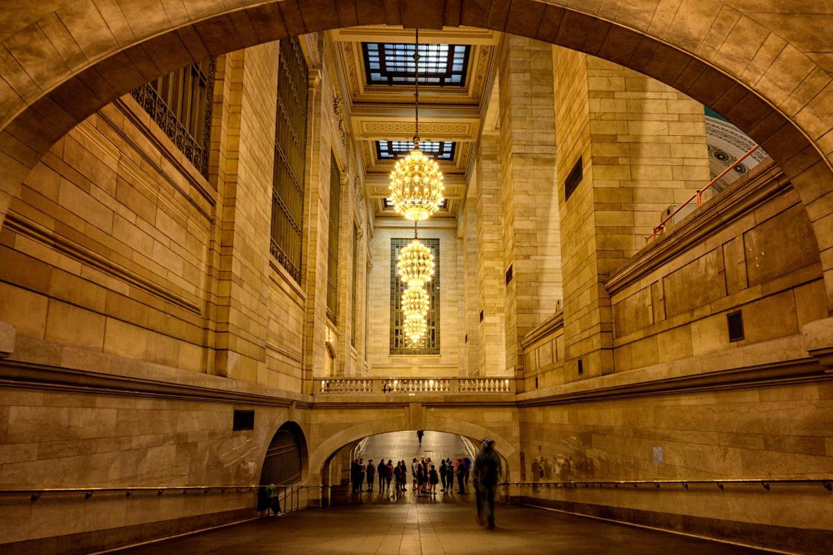 a hallway in a large building with a chandelier