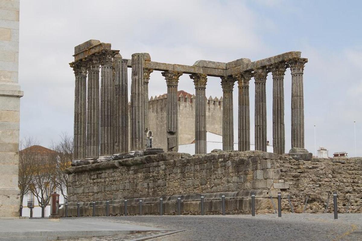 an ancient building with columns in front of a building