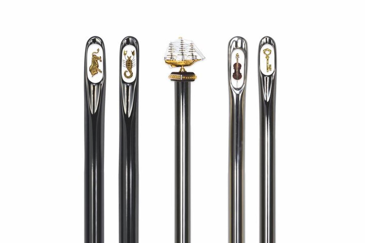three black metal umbrellas on a white background