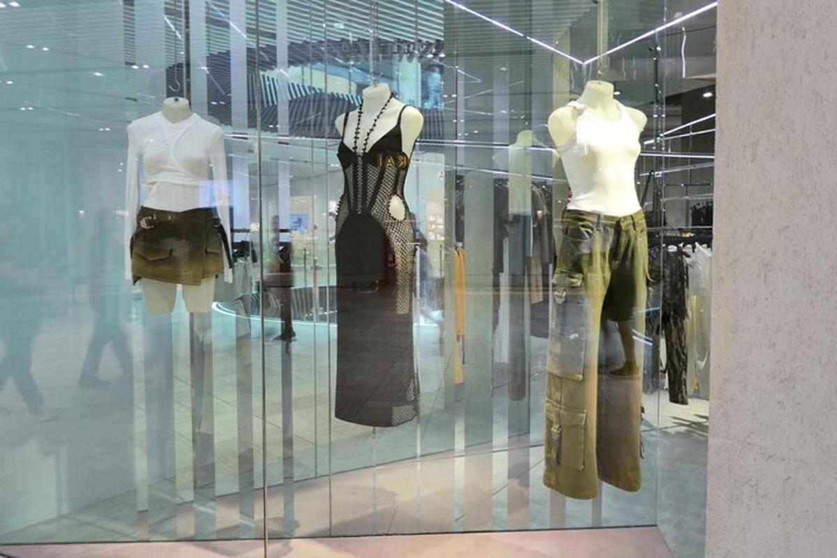 two mannequins in a display window of a store