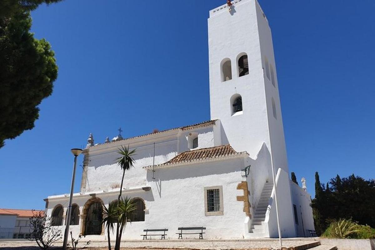 Un edificio blanco con una torre de reloj en la parte superior.