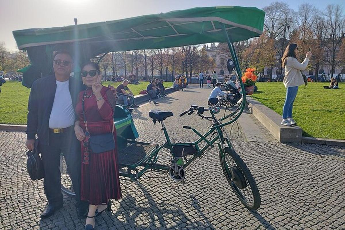 a man and a woman standing next to a bike