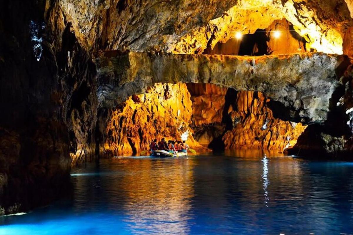 a group of people in a boat in a cave