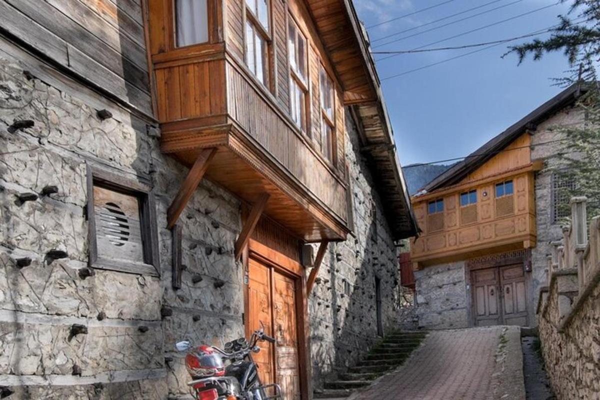 a motorcycle parked next to a building with a wooden door