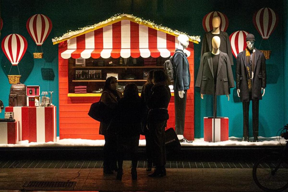 a group of people standing in front of a christmas display
