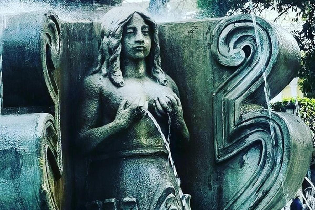 a statue of a woman with a water fountain