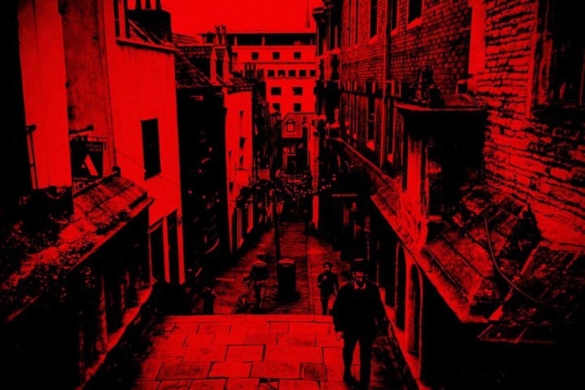 a man and woman walking down a brick street