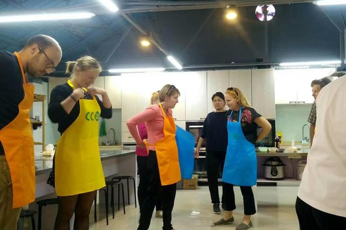 a group of people standing in a kitchen