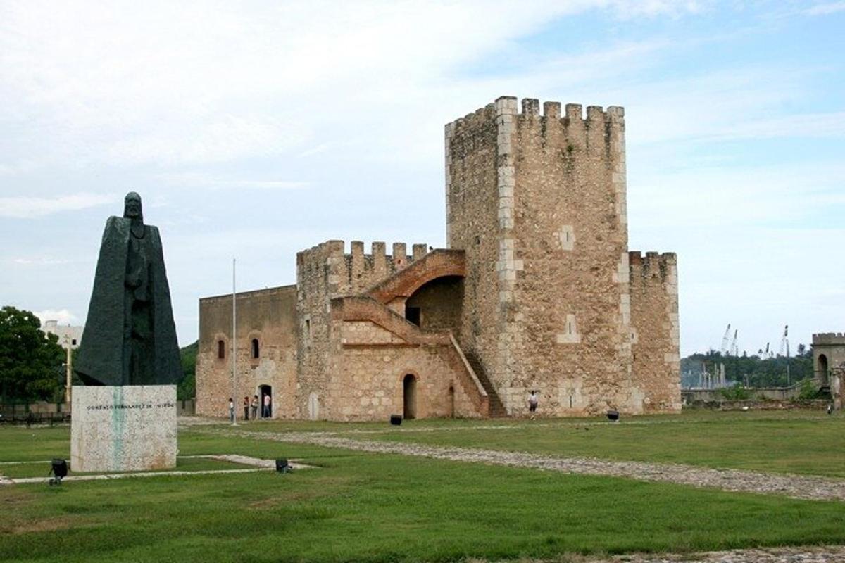 an old castle with a statue in front of it