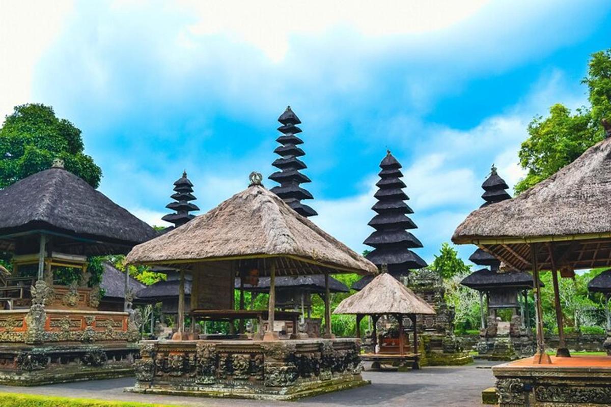 a group of buildings with thatched roofs and towers