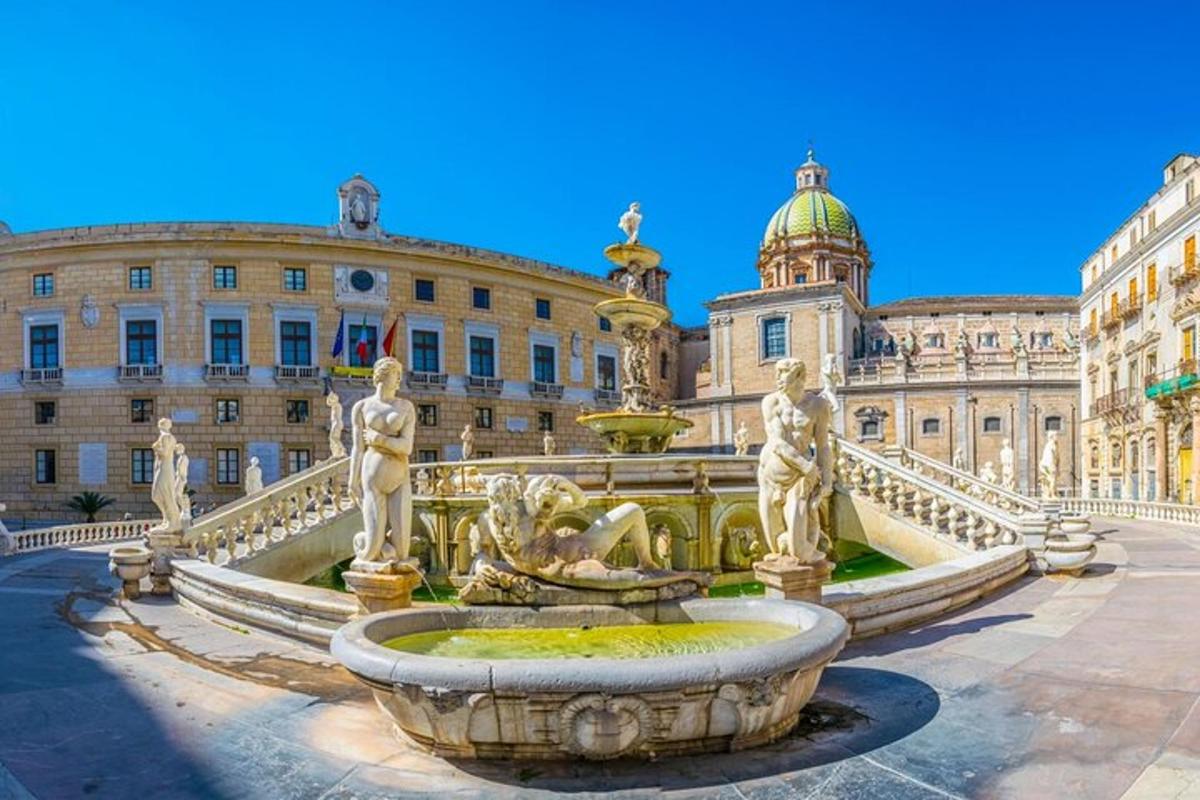 un grande edificio con una fontana di fronte
