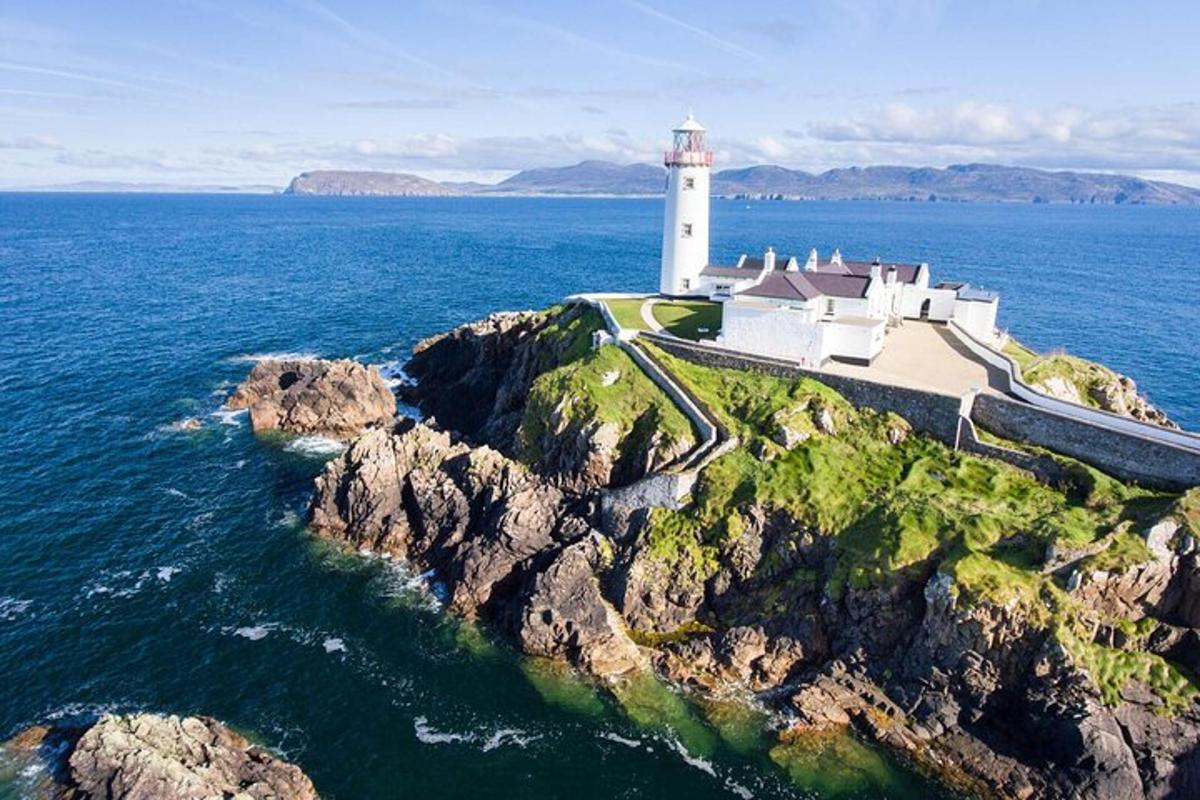 a lighthouse on a rocky island in the ocean