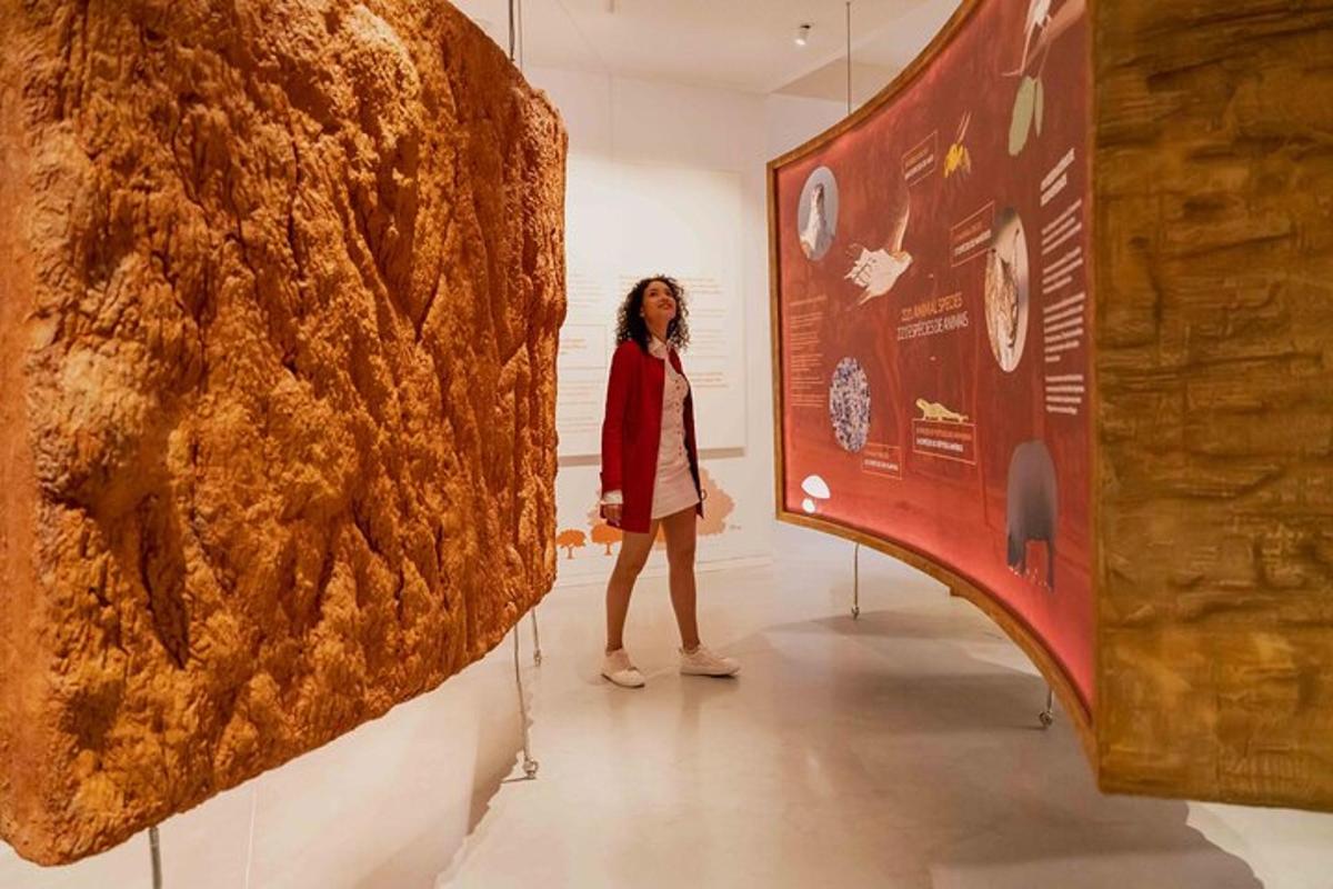a woman standing in front of a large piece of art