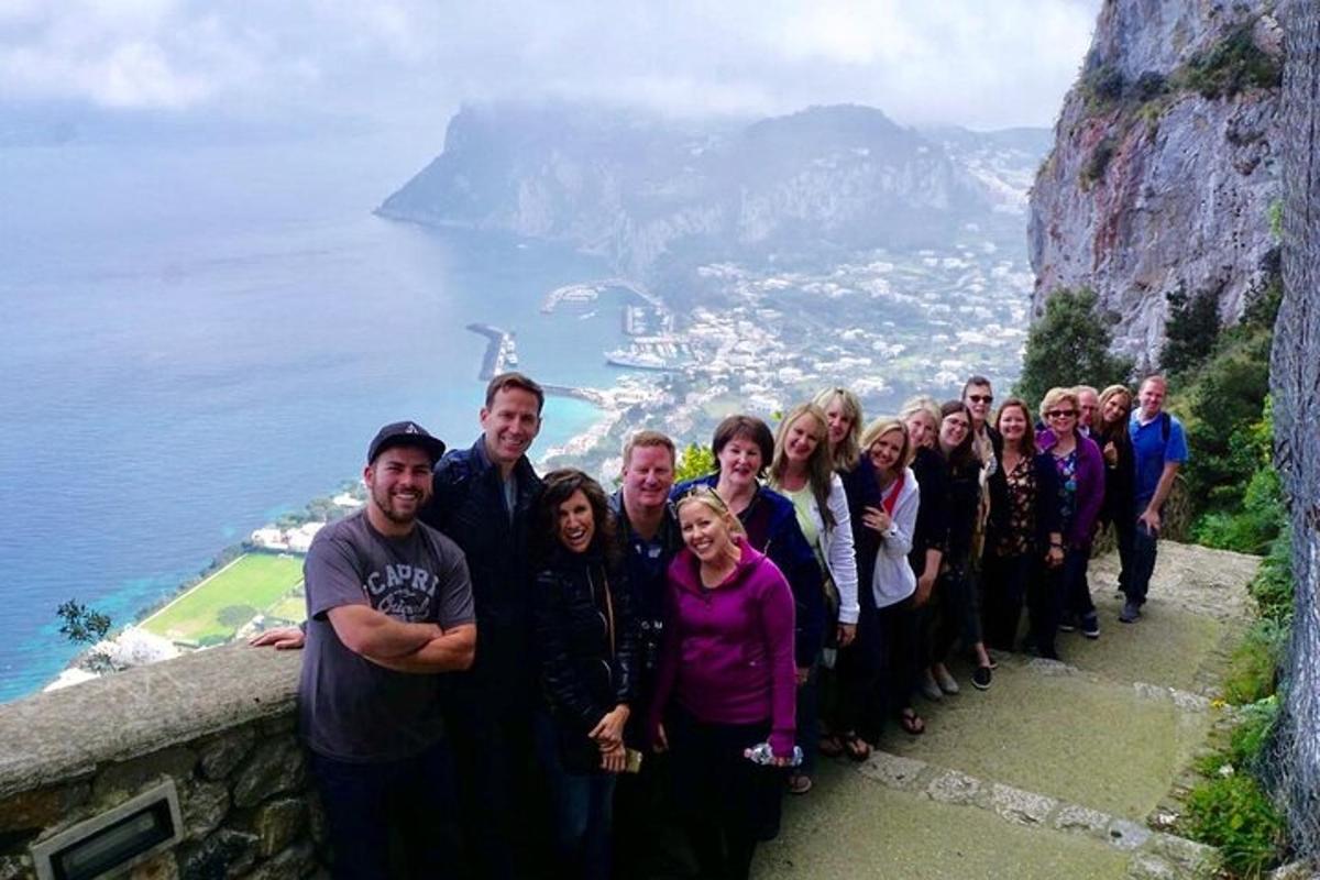 a group of people standing on the edge of a mountain