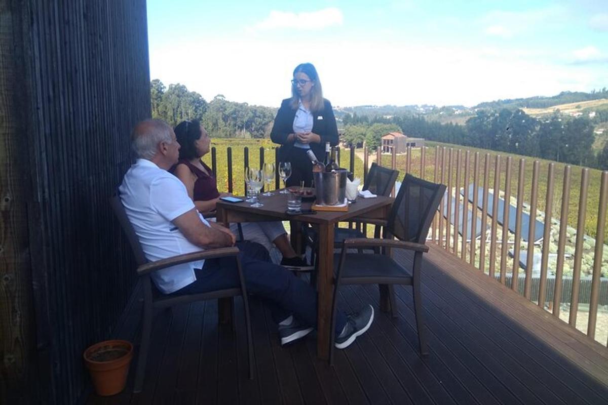 a group of people sitting at a table on a deck