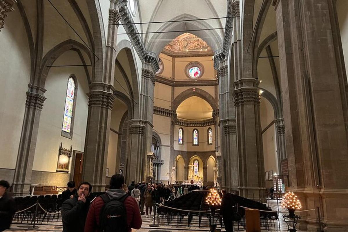a group of people standing in a large cathedral