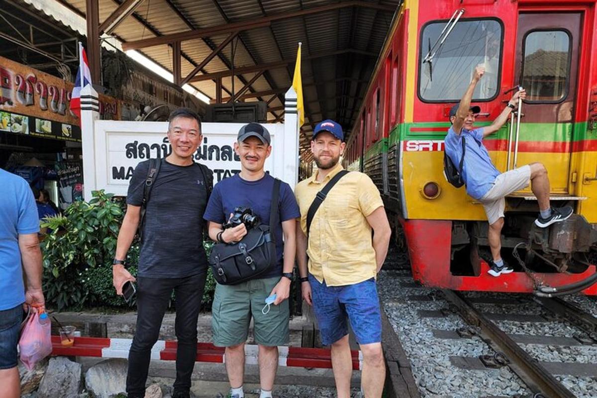 a group of men standing in front of a train