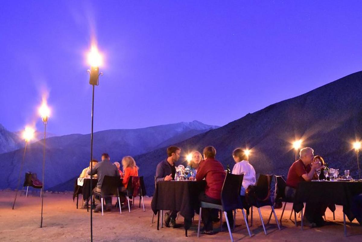 a group of people sitting at tables at night