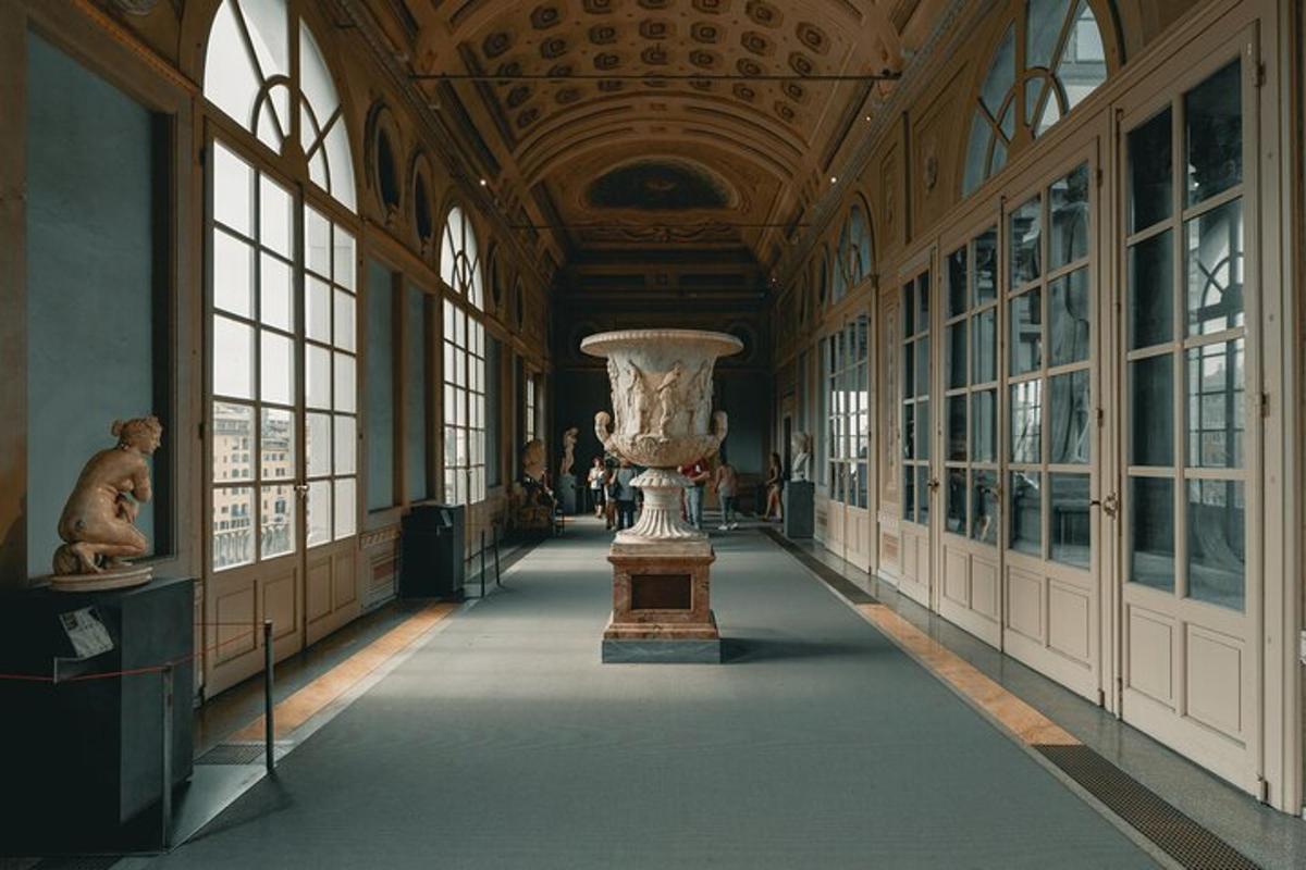 a hallway with a vase in a building with windows