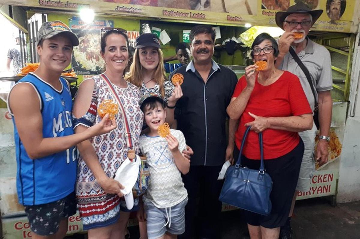 sekumpulan orang bergambar sambil makan makanan