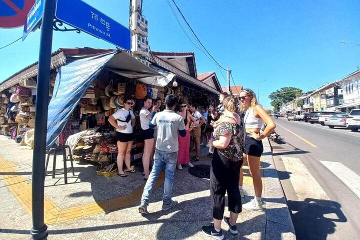 a group of people standing in front of a market
