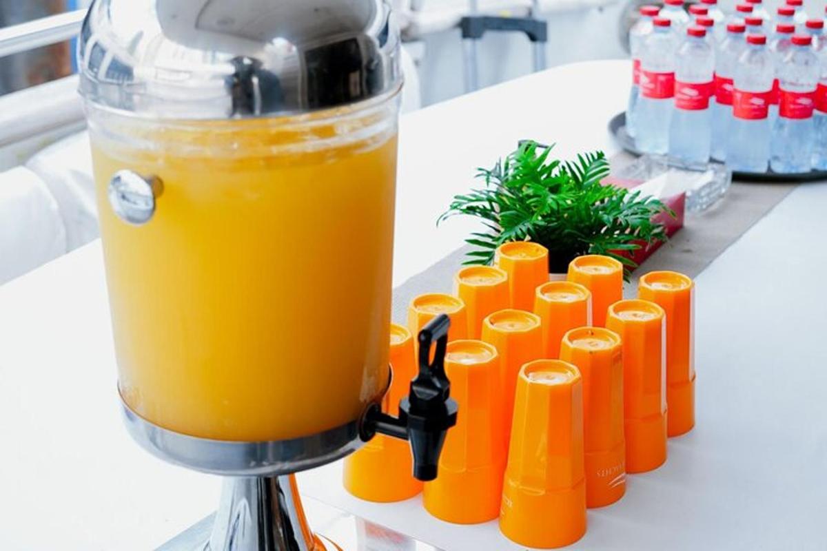 a blender filled with orange juice on a table