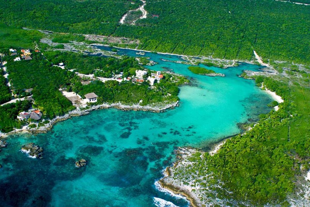 an aerial view of an island with blue water