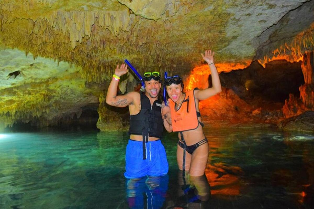 dalawang taong nakatayo sa tubig sa isang kuweba