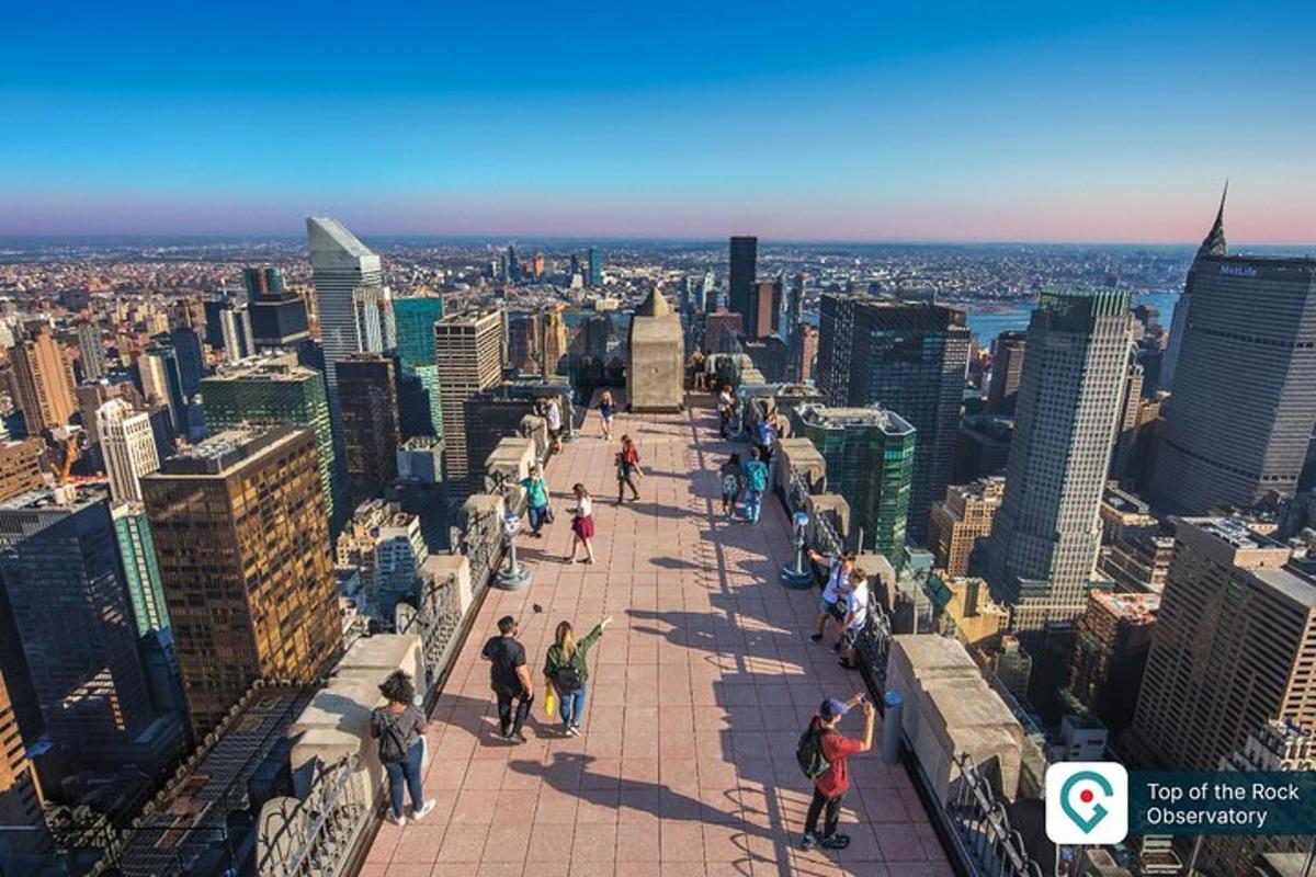 a group of people standing on the top of a skyscraper