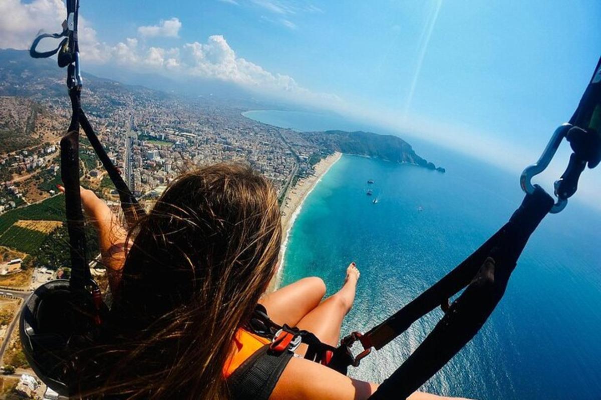 a woman flying in a zip line over the ocean