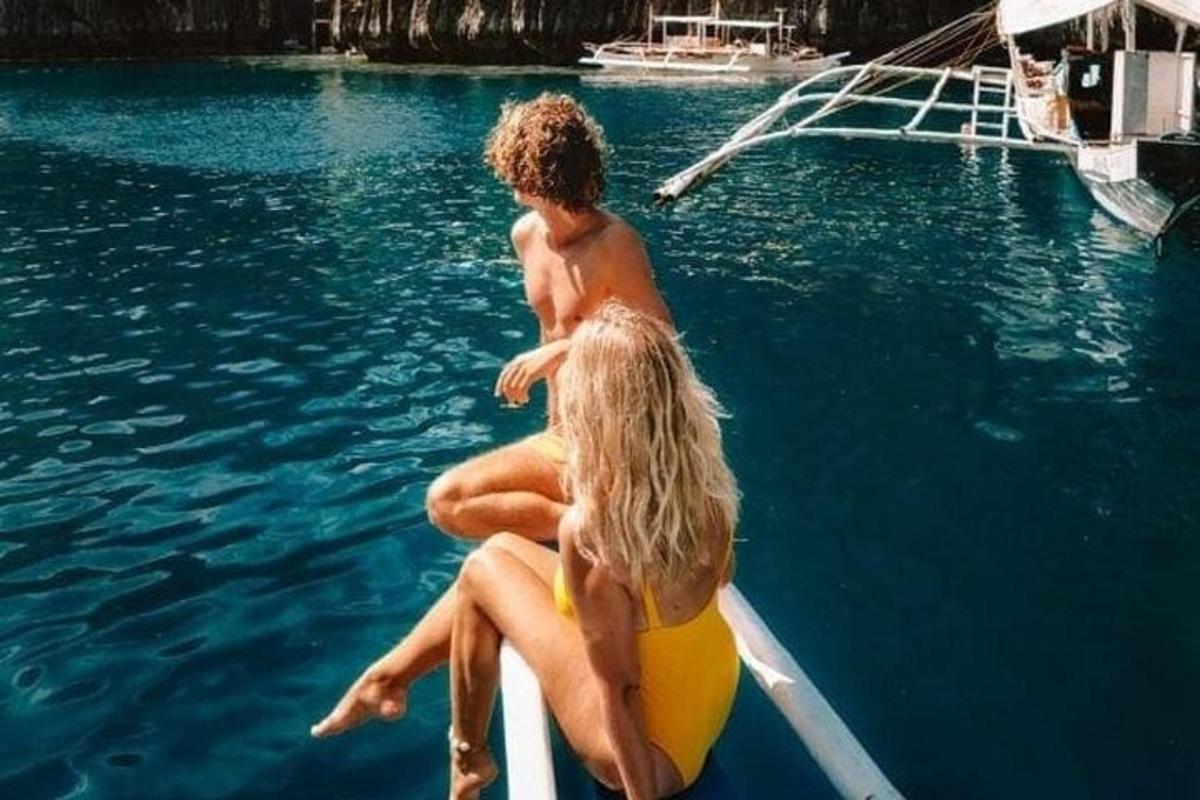 two people sitting on a raft on a boat in the water