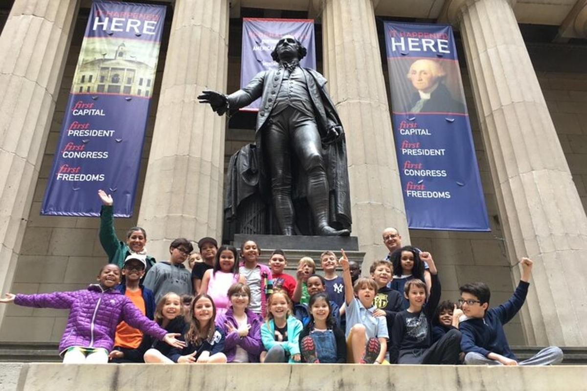 a group of people posing in front of a statue