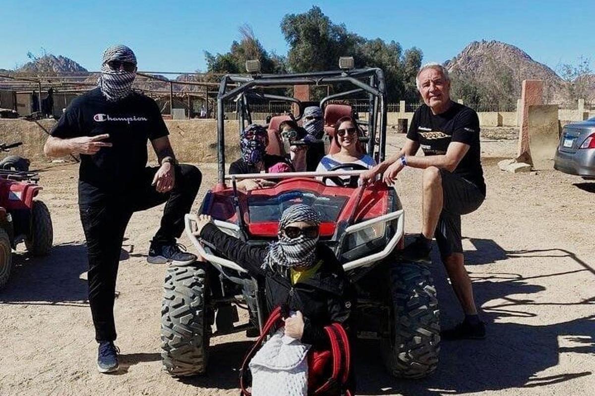 a group of people wearing masks standing next to a four wheeler