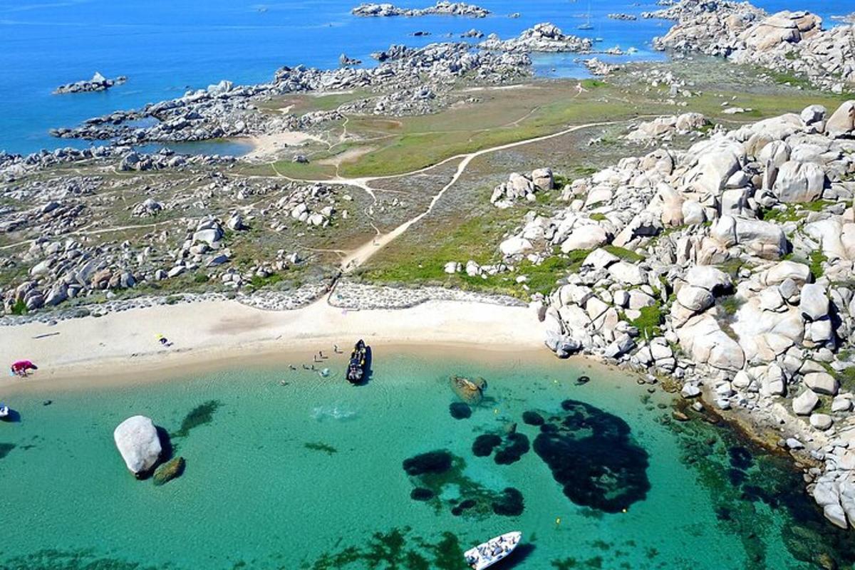an aerial view of a beach with rocks and water
