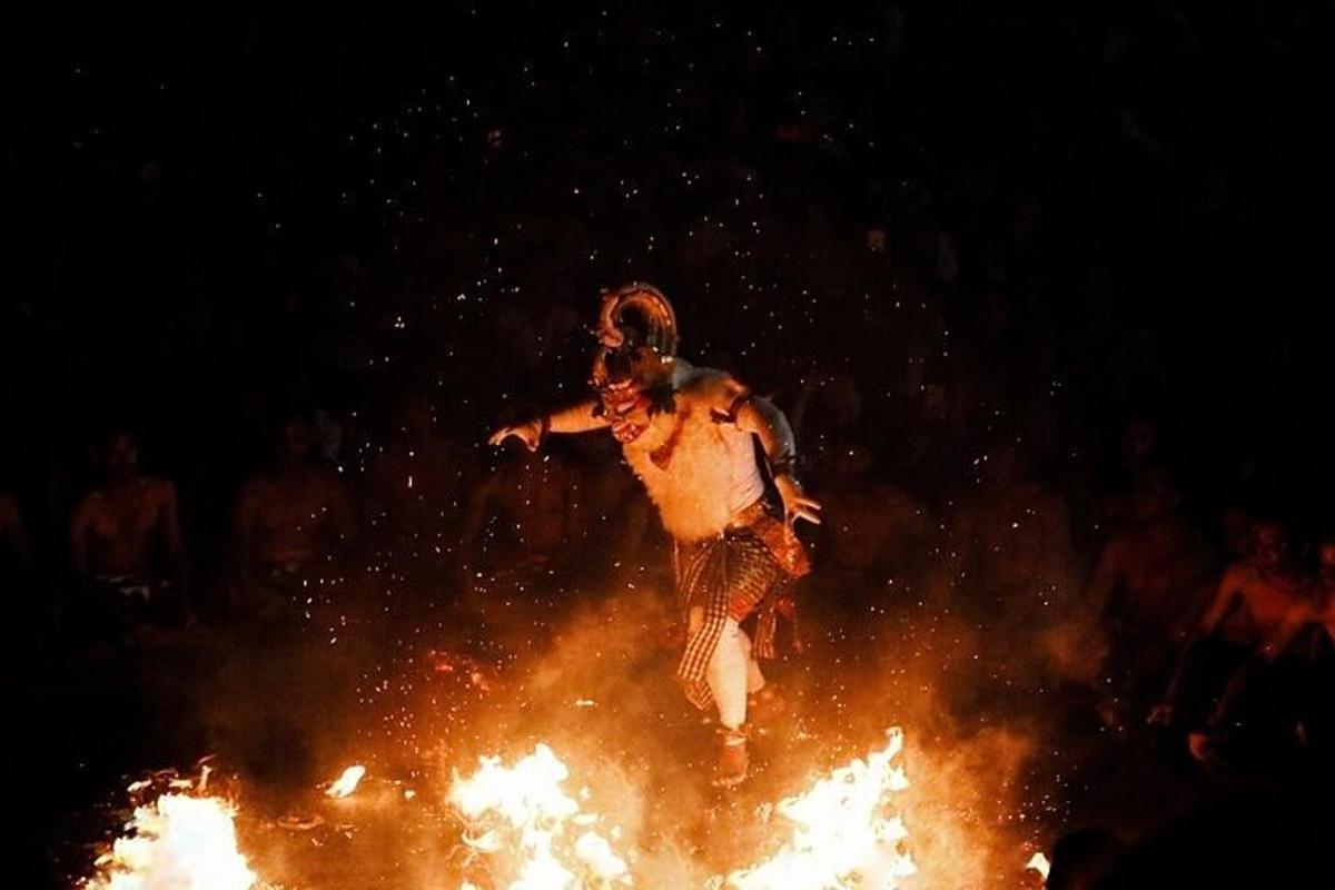 a man jumping on top of a pile of fire