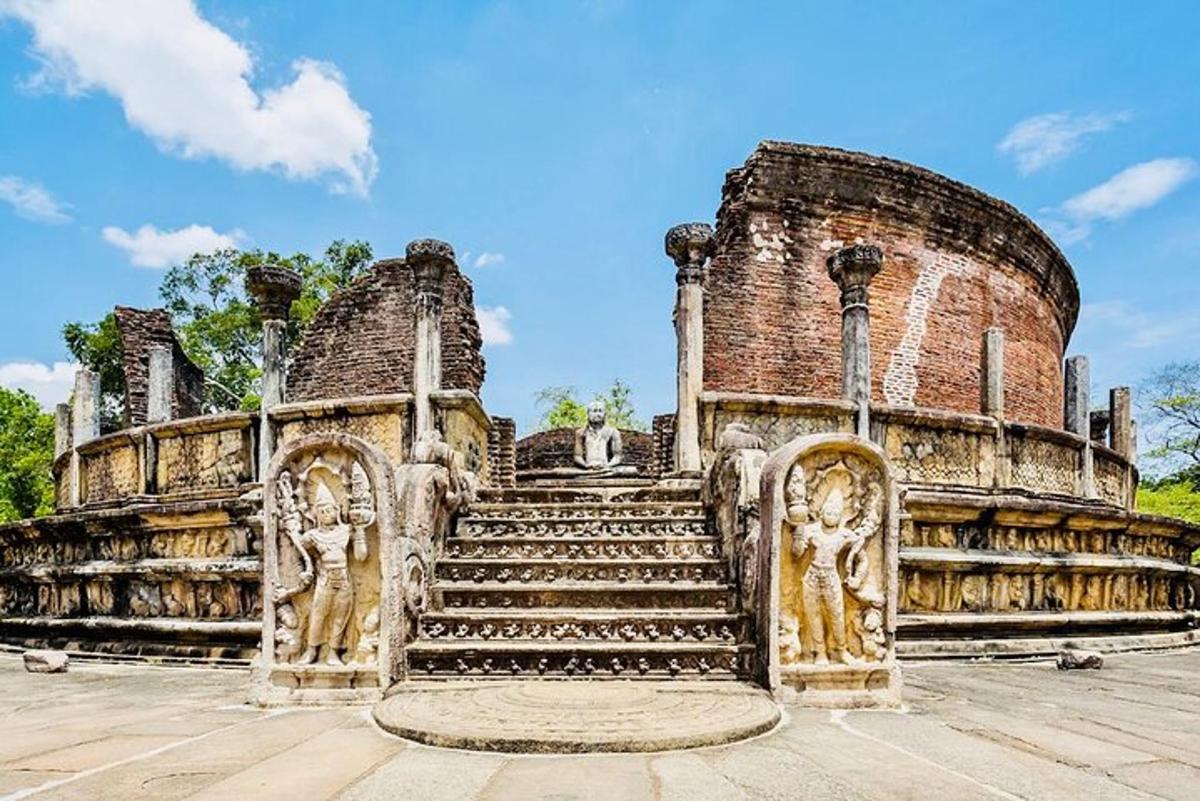 an old building with stairs and statues on it
