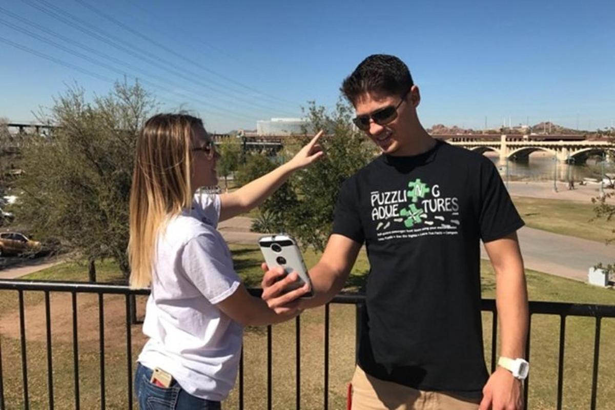 a man and a woman looking at a cell phone