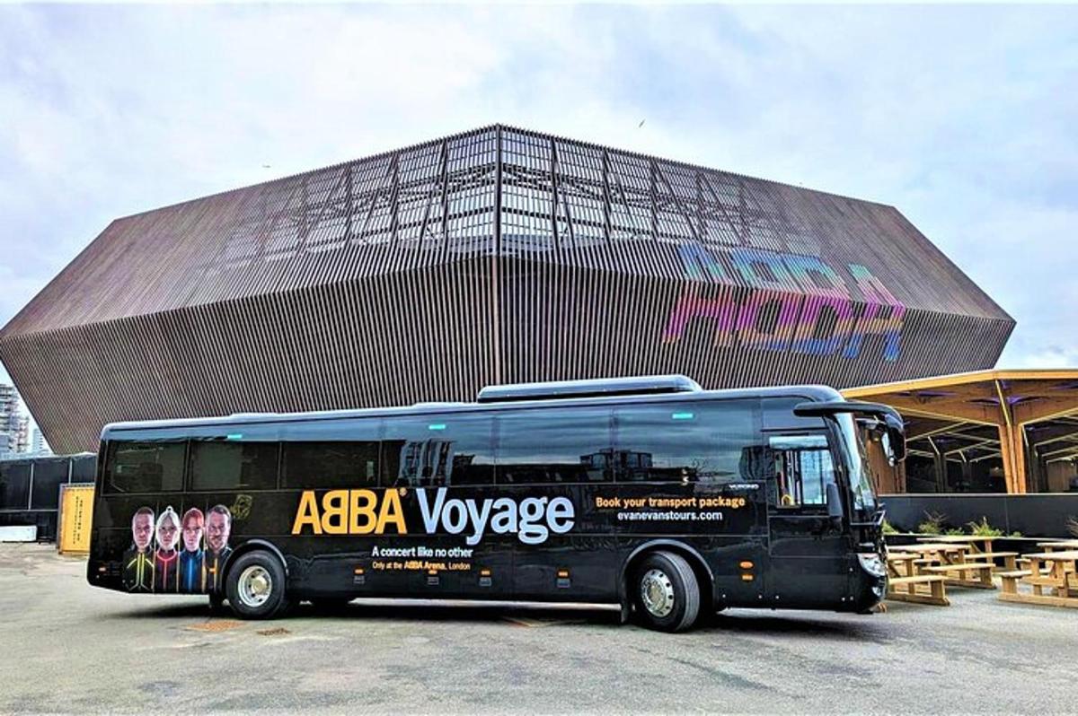 a black bus parked in front of a large building