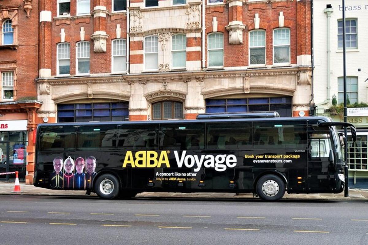 a black bus parked in front of a building
