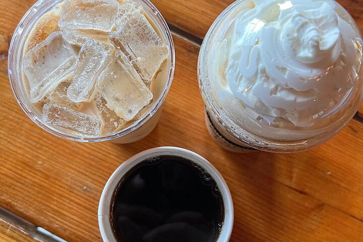 a table with a cup of coffee and a jar of ice cream