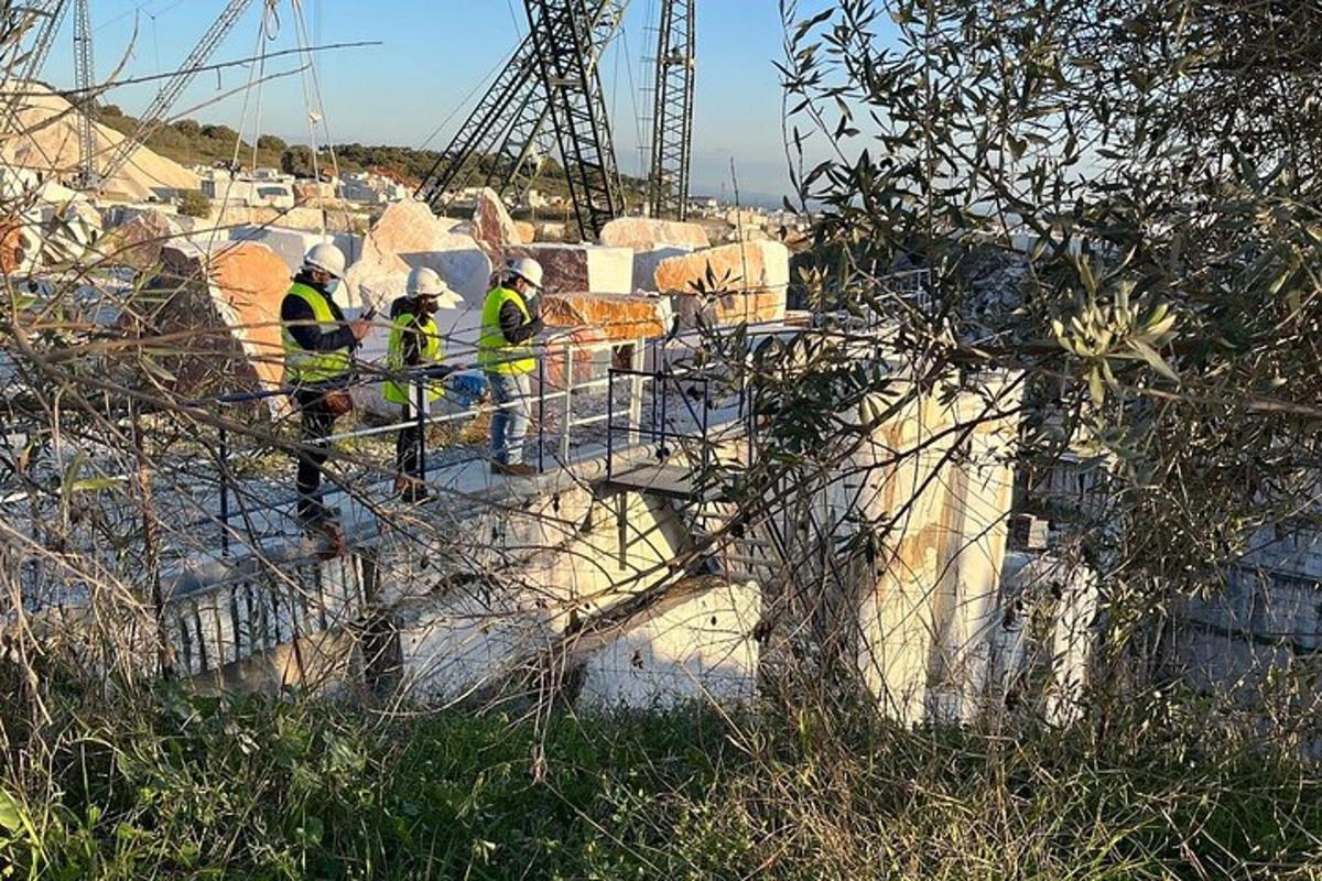 a group of construction workers in yellow vests on a bridge