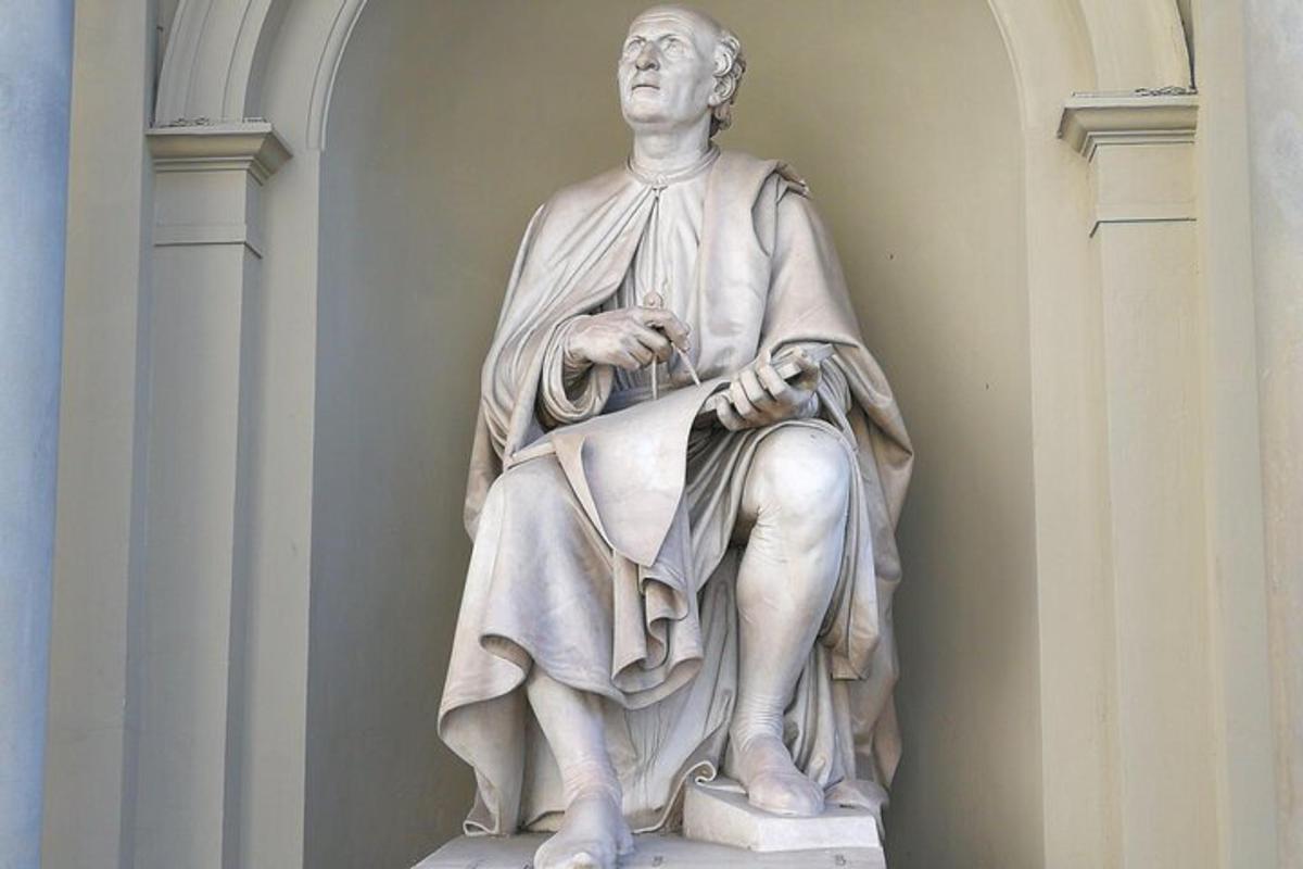 a statue of a man sitting on a pedestal
