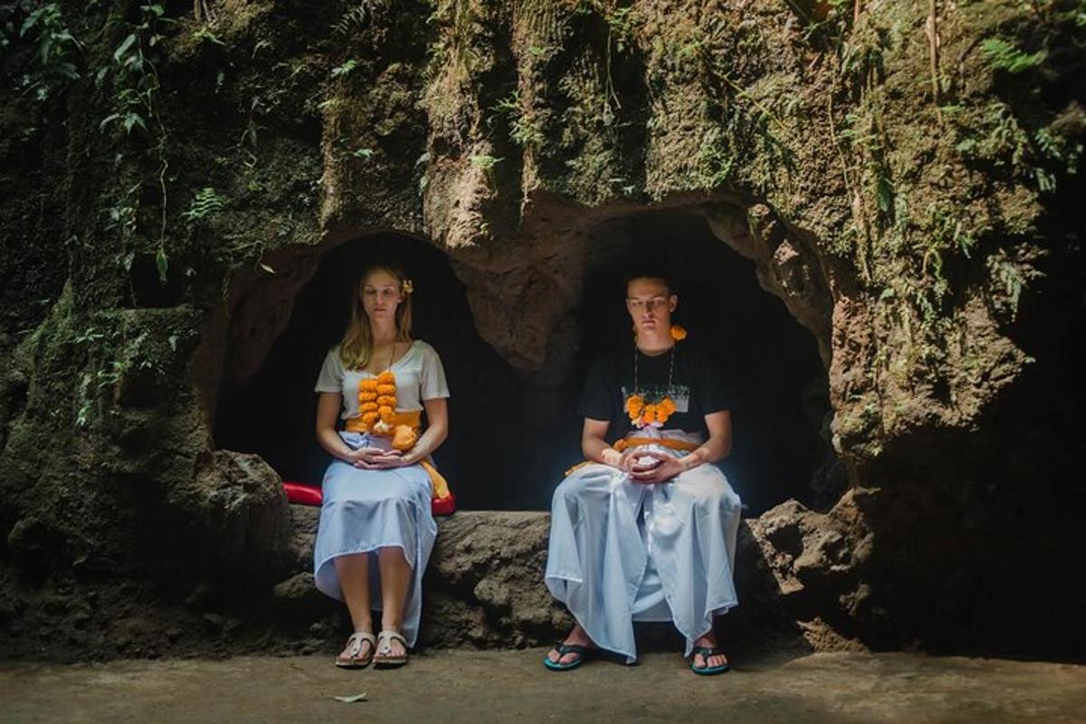 a man and a woman sitting in a cave